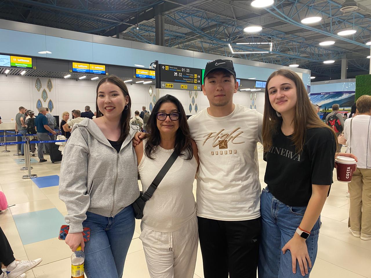 Host mom, Janie, with World Link alumni, Damelya, Askar, and Yaroslava, at the airport in Kazakhstan.