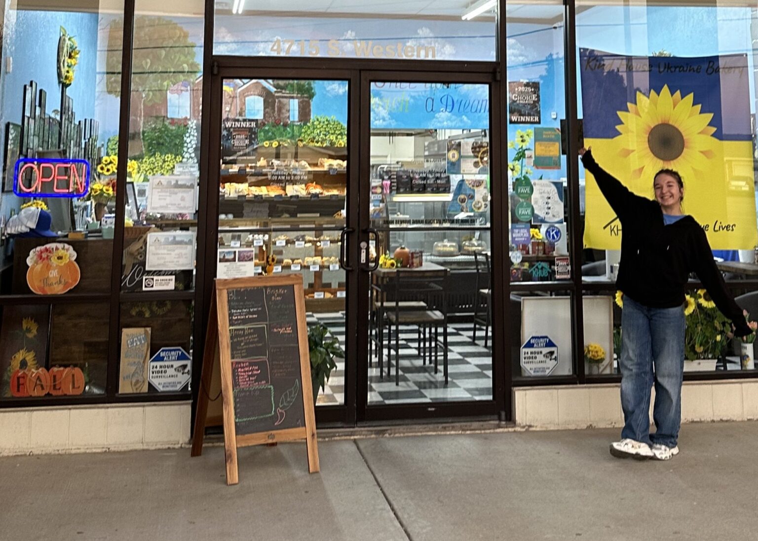 Viktoriia in front of the bakery.